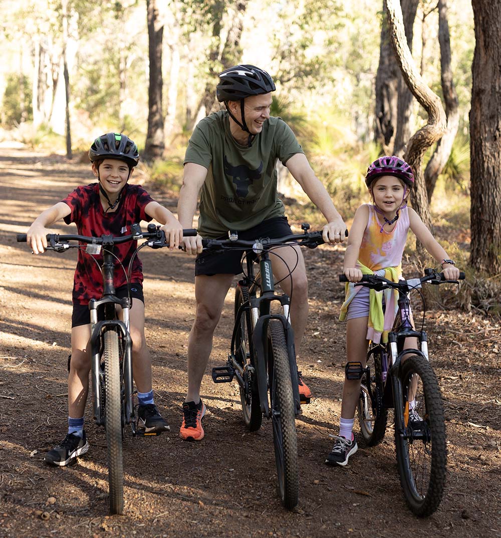 A father and his children going for a ride in the Cardup Nature reserve, located next to Constellar land development