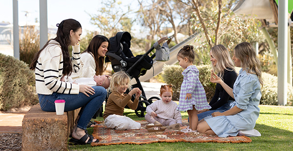 A group of young families enjoying their time in one of Contellars parks, a family friendly land development with community in mind